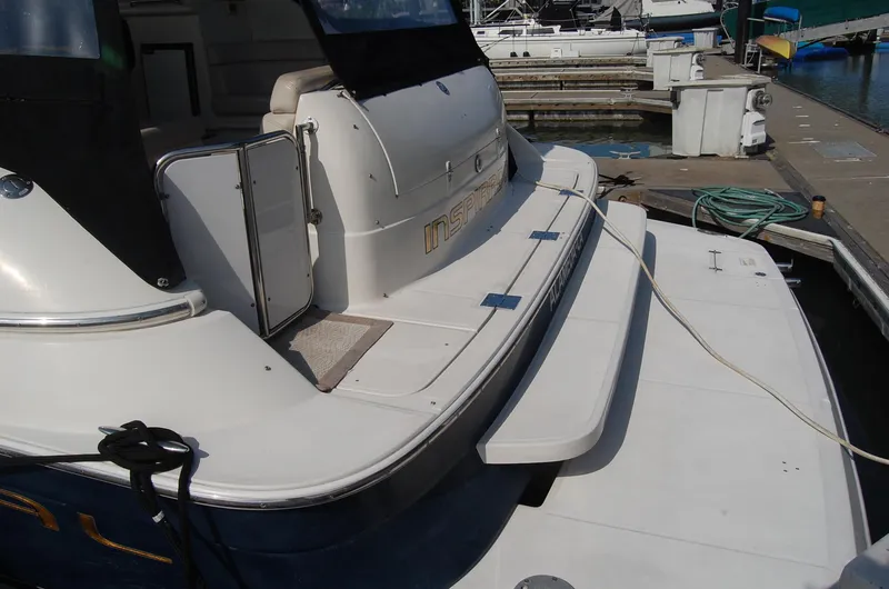Slide: The Image of Rear view of a 2002 Regal Commodore 4260 yacht docked at a marina. - 48