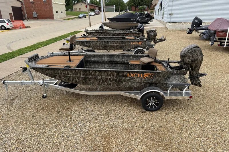 The Image of 2026 Excel 1860 Viper F4 boats on trailers, camo design, parked outdoors. - 1