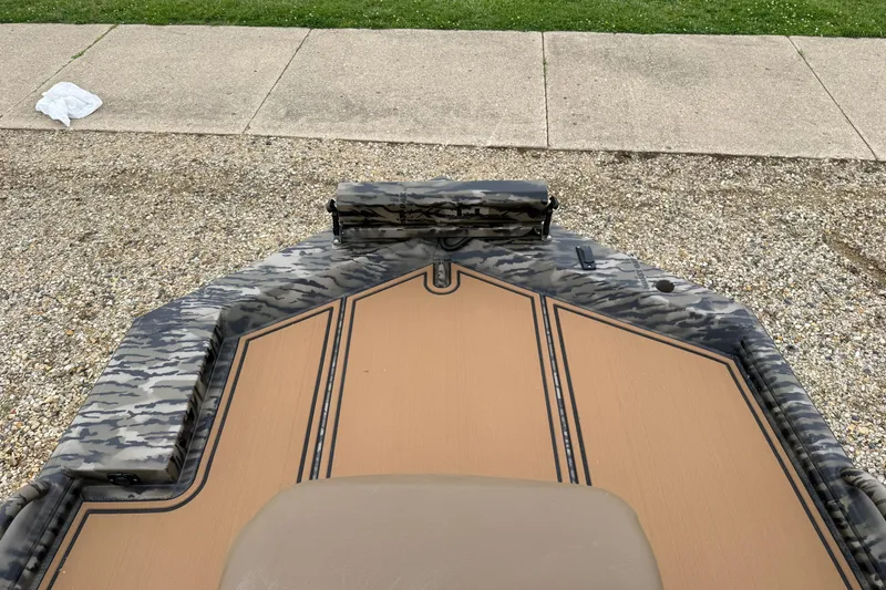Slide: The Image of 2026 Excel 1860 Viper F4 boat with camouflage design on gravel surface. - 10