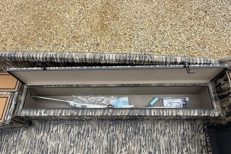 Slide: The Image of Storage compartment of 2026 Excel 1860 Viper F4 boat with camo design and equipment inside. - 13