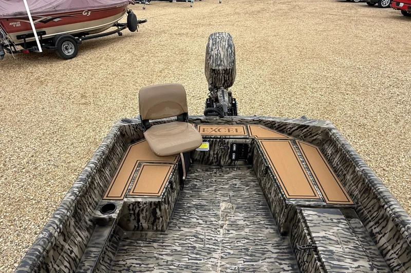 Slide: The Image of 2026 Excel 1860 Viper F4 boat with camouflage design and seating, displayed on gravel. - 14