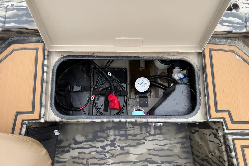 Slide: The Image of Open storage compartment of 2026 Excel 1860 Viper F4 boat, showing wiring and components. - 18
