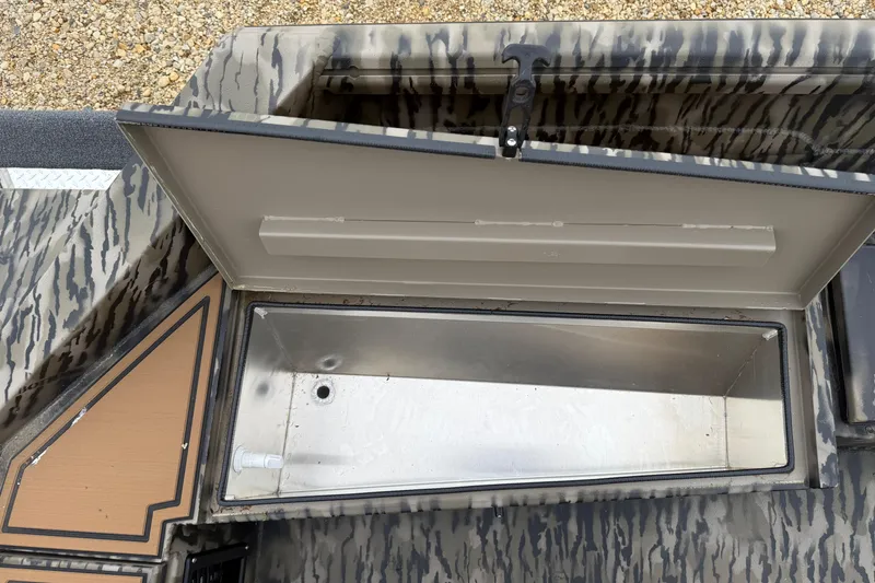 Slide: The Image of Open storage compartment in 2026 Excel 1860 Viper F4 boat, featuring camouflage design. - 19