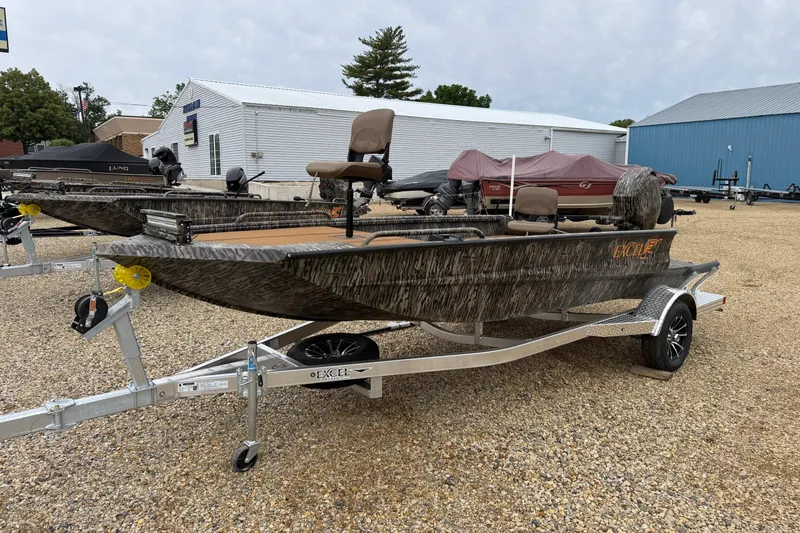 Slide: The Image of 2026 Excel 1860 Viper F4 boat on trailer, camo design, parked outdoors. - 2