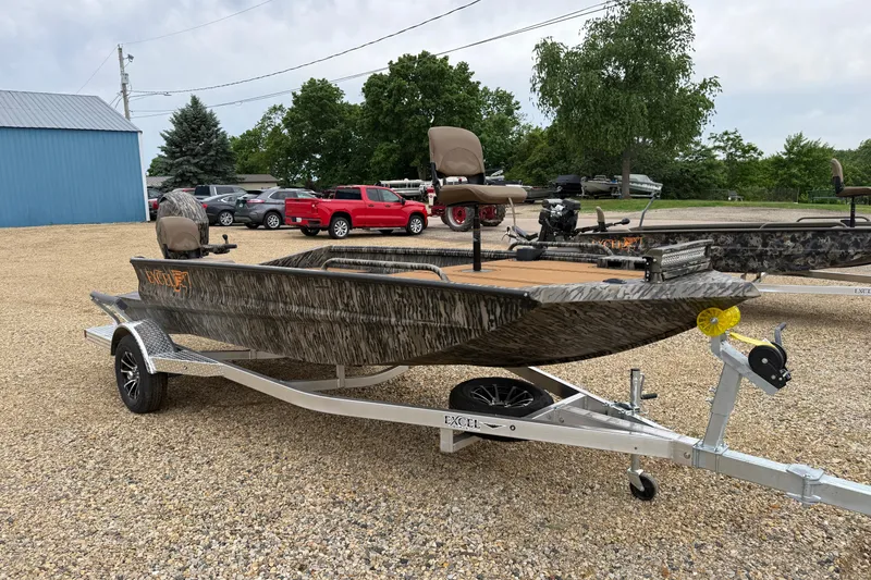 Slide: The Image of 2026 Excel 1860 Viper F4 boat on trailer, parked outdoors with trees and vehicles nearby. - 3
