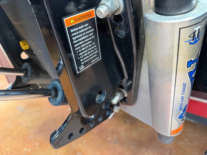 Slide: The Image of Falcon T20TE 2022 motor mount with warning label and hydraulic cylinder. - 20