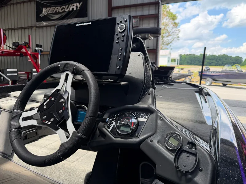 Slide: The Image of Interior view of 2024 Skeeter FXR20 boat with steering wheel and electronics. - 15