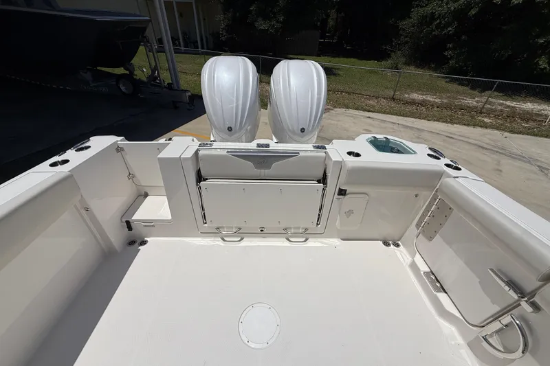 Slide: The Image of 2026 Sailfish 312 CC boat deck with dual outboard motors, spacious layout. - 12