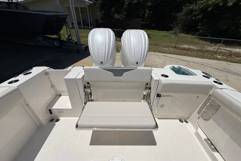 Slide: The Image of 2026 Sailfish 312 CC boat interior with dual engines and seating area. - 13