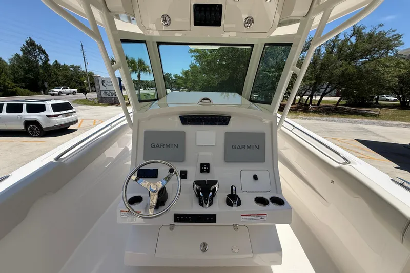 Slide: The Image of 2026 Sailfish 312 CC boat helm with Garmin navigation system and steering wheel. - 14