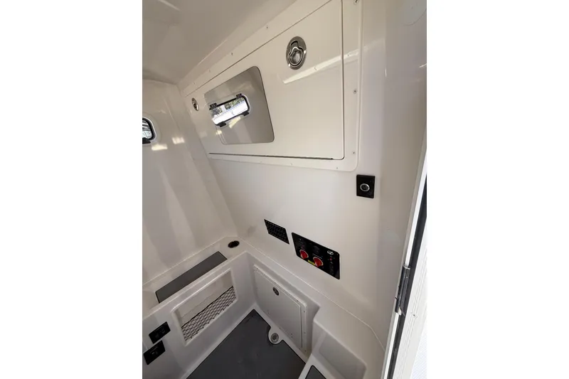 Slide: The Image of Interior view of 2026 Sailfish 312 CC boat cabin, featuring storage and control panels. - 26