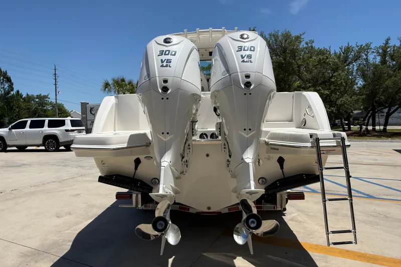 Slide: The Image of 2026 Sailfish 312 CC boat with dual 300 V6 engines, parked outdoors. - 4