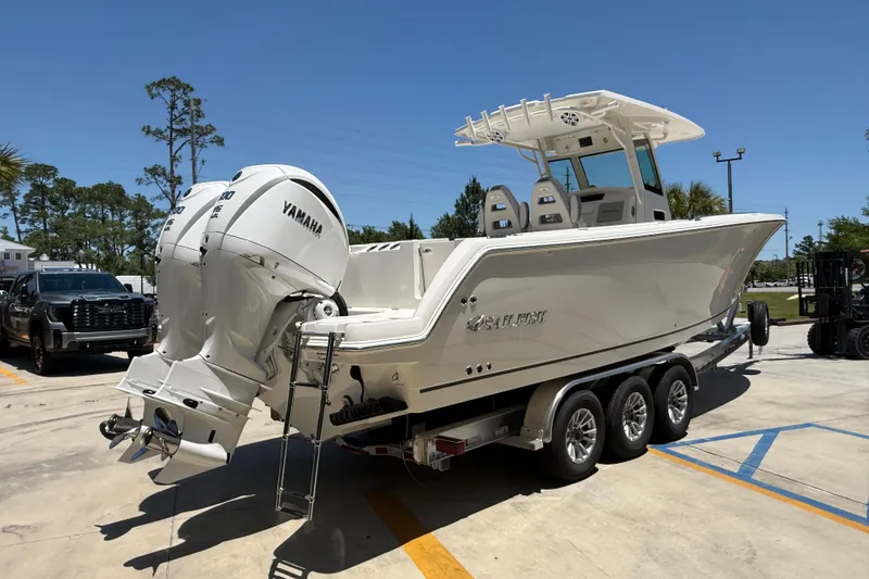 Slide: The Image of 2026 Sailfish 312 CC boat with Yamaha engines on a trailer in a sunny parking lot. - 5