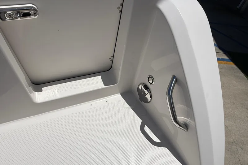 Slide: The Image of Interior view of 2026 Sailfish 312 CC boat, featuring a sleek handle and textured flooring. - 8