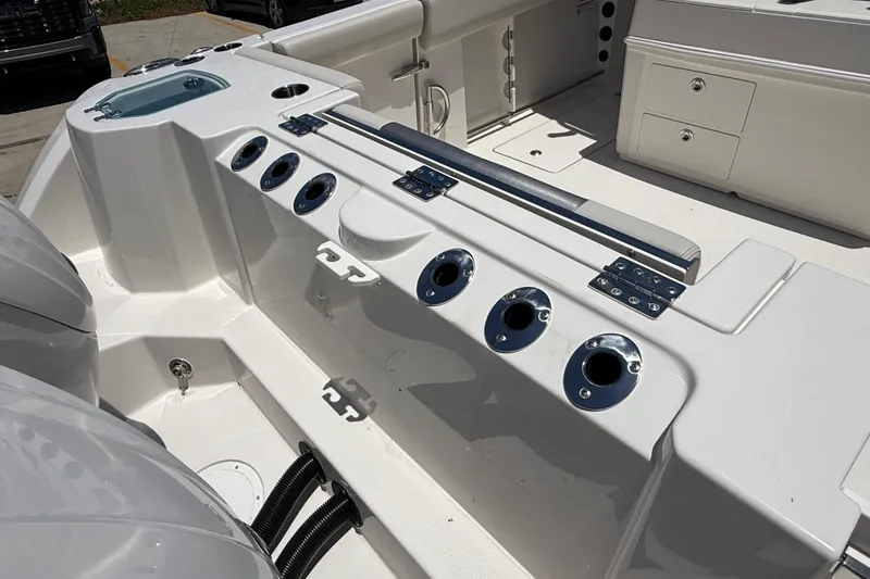 Slide: The Image of 2026 Sailfish 312 CC boat deck with rod holders and storage compartments. - 9