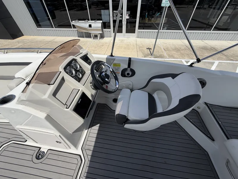 Slide: The Image of Interior of 2023 Starcraft SXV-211 boat with steering console and seat. - 16