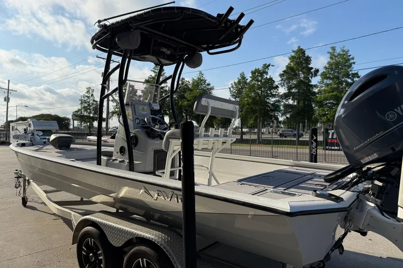 Slide: The Image of 2022 Avid 23 FS Magnum boat on trailer, featuring sleek design and powerful engine. - 11