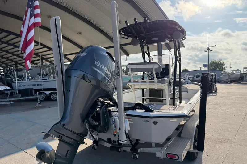 Slide: The Image of 2022 Avid 23 FS Magnum boat with Yamaha engine, displayed outdoors under a canopy. - 12