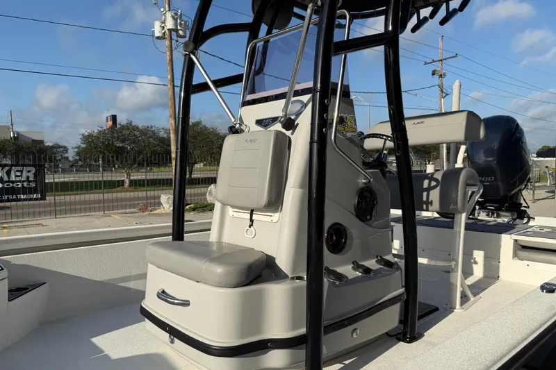 Slide: The Image of 2022 Avid 23 FS Magnum boat with seating and console, parked outdoors. - 8