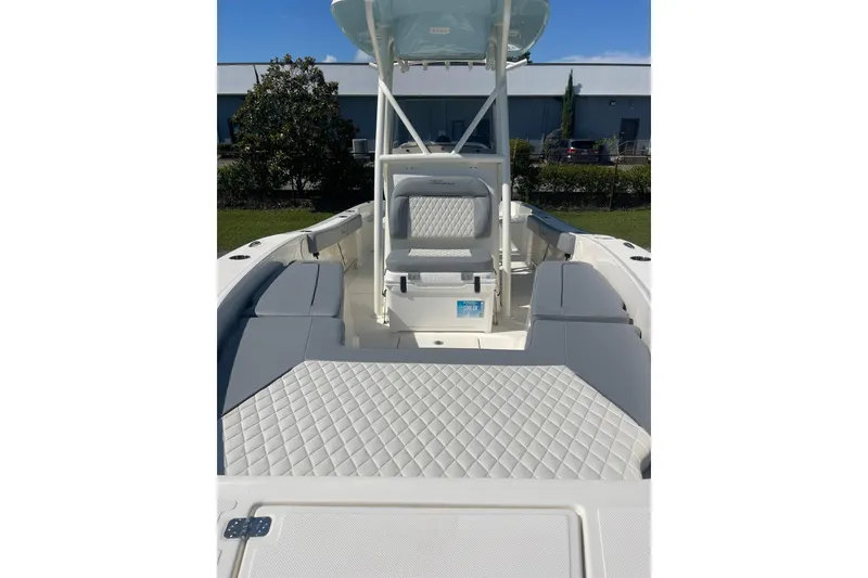 Slide: The Image of 2026 Pioneer 220 Bay Sport boat interior with cushioned seating and console. - 14