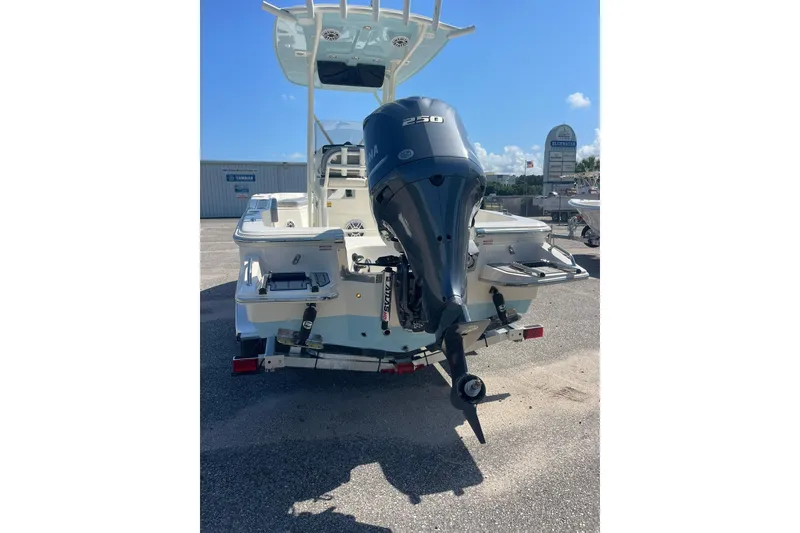 Slide: The Image of 2026 Pioneer 220 Bay Sport boat with Yamaha 250 outboard motor, parked outdoors. - 15