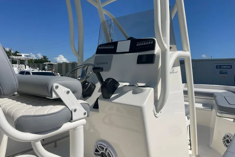 Slide: The Image of 2026 Pioneer 220 Bay Sport boat console with Garmin electronics, featuring a sleek design and comfortable seating. - 16