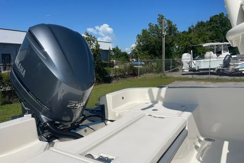 Slide: The Image of 2026 Pioneer 220 Bay Sport boat with Yamaha 250 engine, parked outdoors. - 17