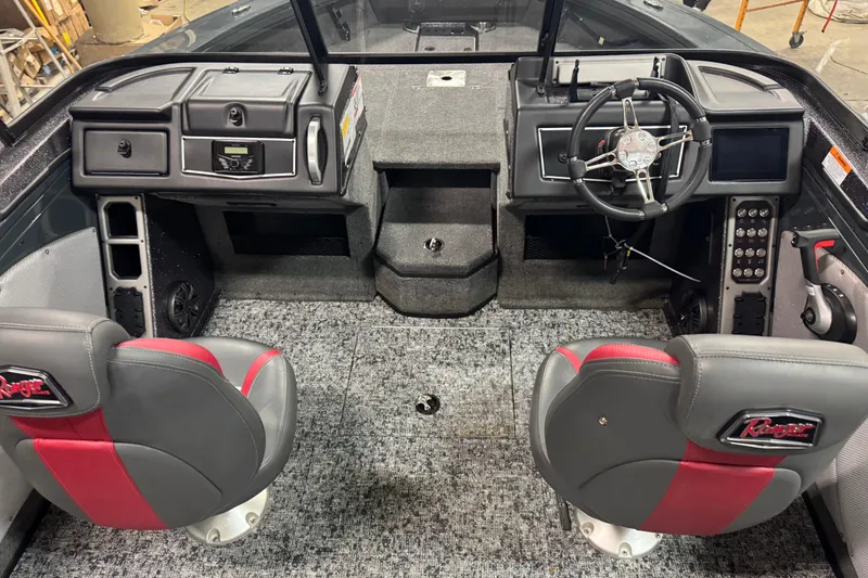 Slide: The Image of 2024 Ranger VX1888 WT boat interior with steering wheel, dashboard, and two seats. - 12
