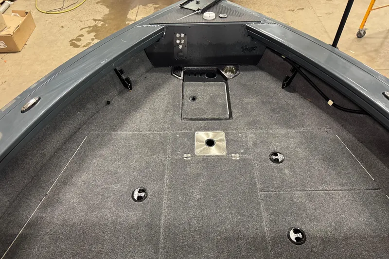 Slide: The Image of 2024 Ranger VX1888 WT boat interior with carpeted deck and storage compartments. - 13