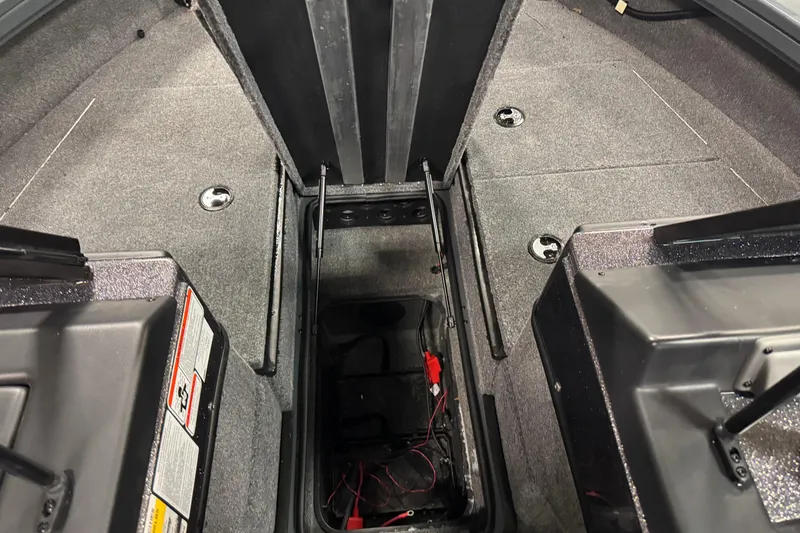 Slide: The Image of 2024 Ranger VX1888 WT boat interior with open storage compartment and carpeted flooring. - 14