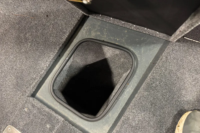 Slide: The Image of 2024 Ranger VX1888 WT boat storage compartment with carpeted interior. - 16
