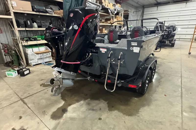 Slide: The Image of 2024 Ranger VX1888 WT boat in a garage, showcasing powerful outboard motor. - 3