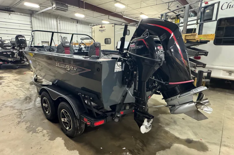 Slide: The Image of 2024 Ranger VX1888 WT boat with dual motors in a garage setting. - 4