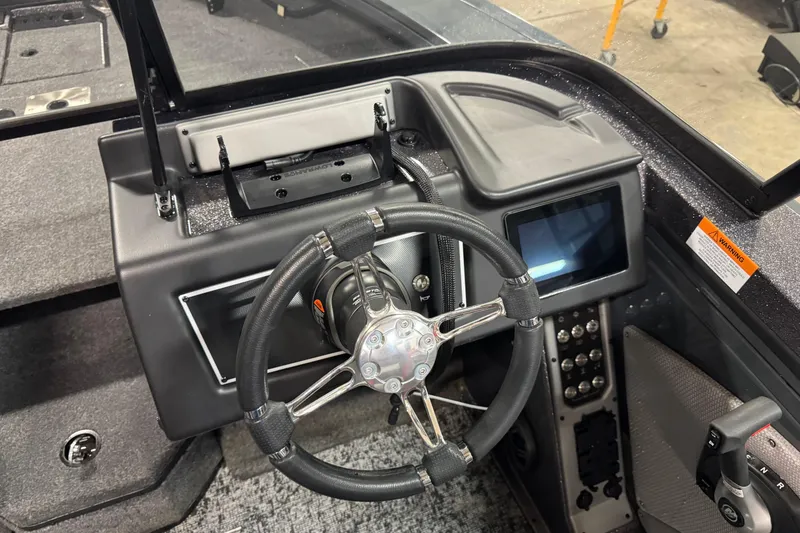 Slide: The Image of 2024 Ranger VX1888 WT boat dashboard with steering wheel and digital display. - 7