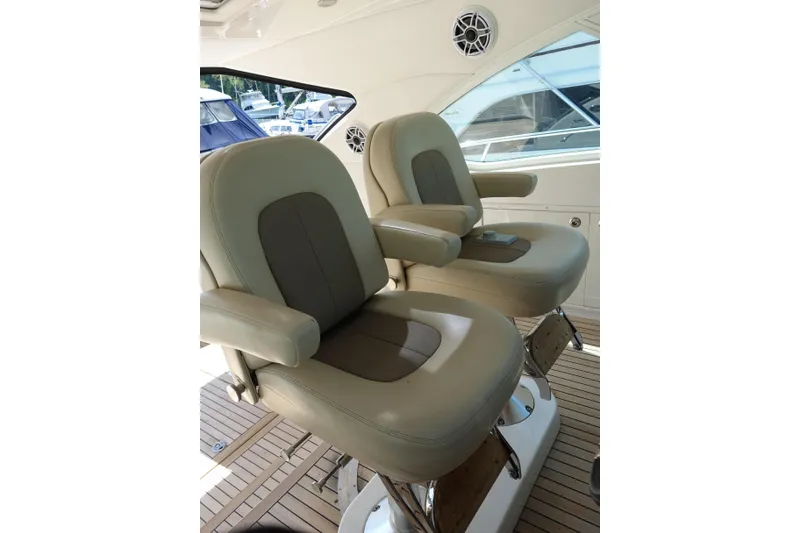 Slide: The Image of Luxury seating on 2012 Sea Ray Sundancer 540 yacht, featuring plush beige captain chairs. - 10