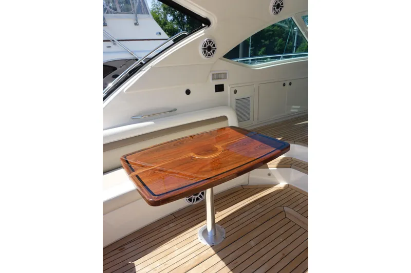 Slide: The Image of Luxurious interior of 2012 Sea Ray Sundancer 540 yacht with elegant wooden table. - 15
