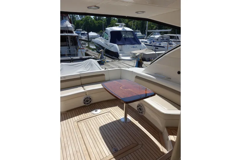 Slide: The Image of Luxurious 2012 Sea Ray Sundancer 540 yacht interior with elegant seating and wooden table. - 16
