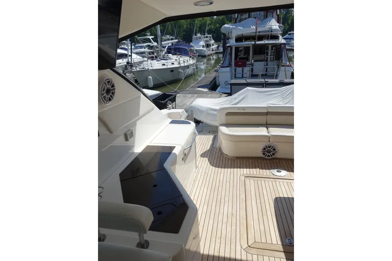 Slide: The Image of 2012 Sea Ray Sundancer 540 yacht interior with spacious deck and marina view. - 17