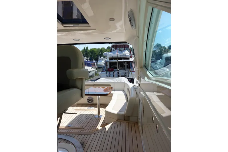 Slide: The Image of Interior view of 2012 Sea Ray Sundancer 540 yacht, featuring luxurious seating and wooden flooring. - 19