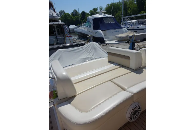 Slide: The Image of 2012 Sea Ray Sundancer 540 yacht with beige seating at a marina. - 20