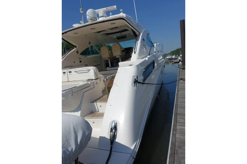 Slide: The Image of 2012 Sea Ray Sundancer 540 yacht docked, showcasing sleek design and luxurious interior. - 23