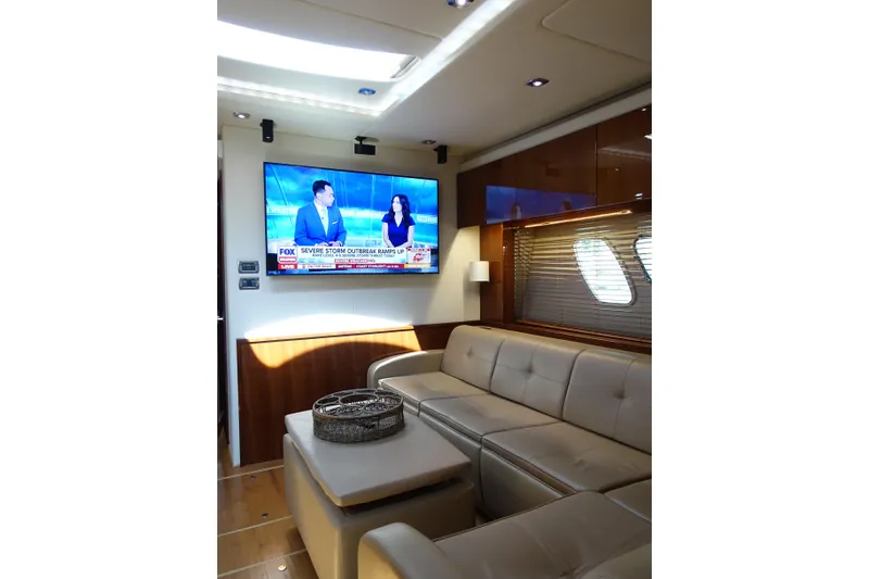 Slide: The Image of Luxurious interior of 2012 Sea Ray Sundancer 540 yacht with leather seating and wall-mounted TV. - 26