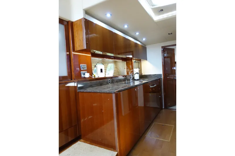 Slide: The Image of Luxurious kitchen interior of 2012 Sea Ray Sundancer 540 yacht with sleek wood cabinetry. - 29