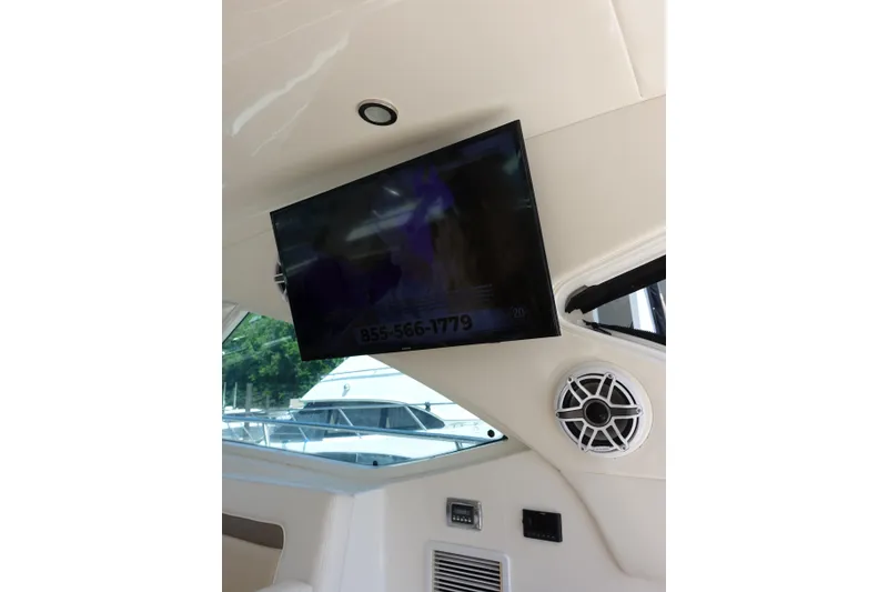 Slide: The Image of 2012 Sea Ray Sundancer 540 interior with mounted TV and speaker system. - 3