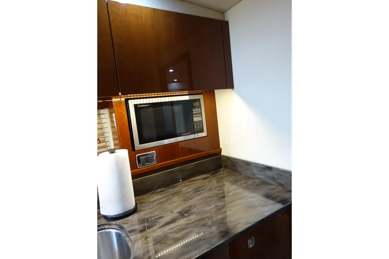 Slide: The Image of 2012 Sea Ray Sundancer 540 kitchen with microwave and marble countertop. - 31