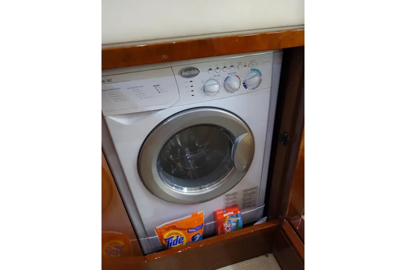 Slide: The Image of Washing machine inside 2012 Sea Ray Sundancer 540 yacht with detergent packs nearby. - 39