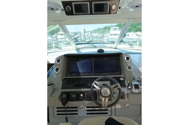 Slide: The Image of Helm of 2012 Sea Ray Sundancer 540 yacht with modern navigation controls and steering wheel. - 4