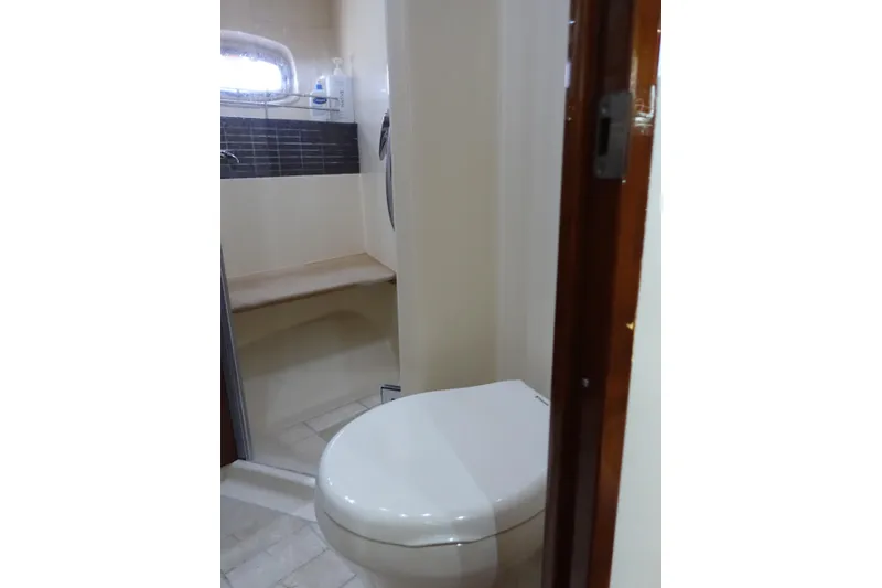 Slide: The Image of Bathroom interior of 2012 Sea Ray Sundancer 540 yacht, featuring toilet and shower area. - 45