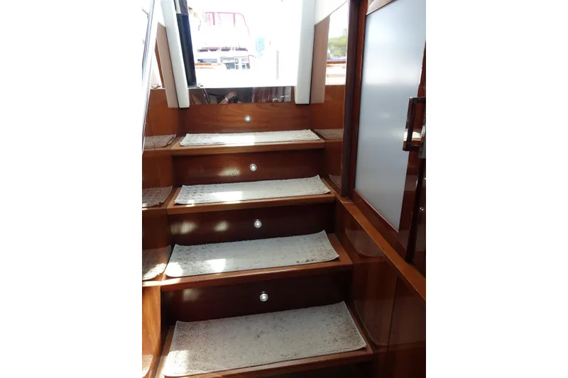 Slide: The Image of Staircase inside 2012 Sea Ray Sundancer 540 yacht with wooden finish and carpeted steps. - 46