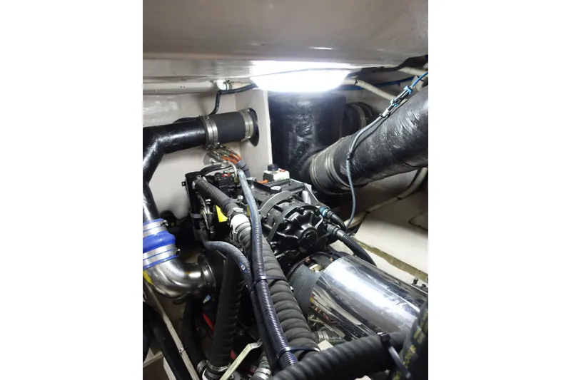 Slide: The Image of Engine room of 2012 Sea Ray Sundancer 540 yacht, showcasing mechanical components and piping. - 49